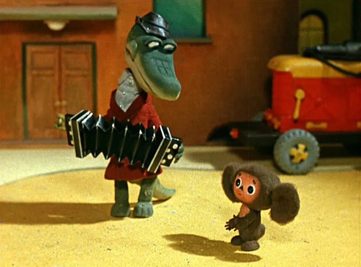 Toy scene with a dinosaur-like puppet holding an accordion and a small brown character, used as a hub hero for creator topics. Toy scene with a dinosaur-like puppet holding an accordion and a small brown character, used as a hub hero for creator topics.
