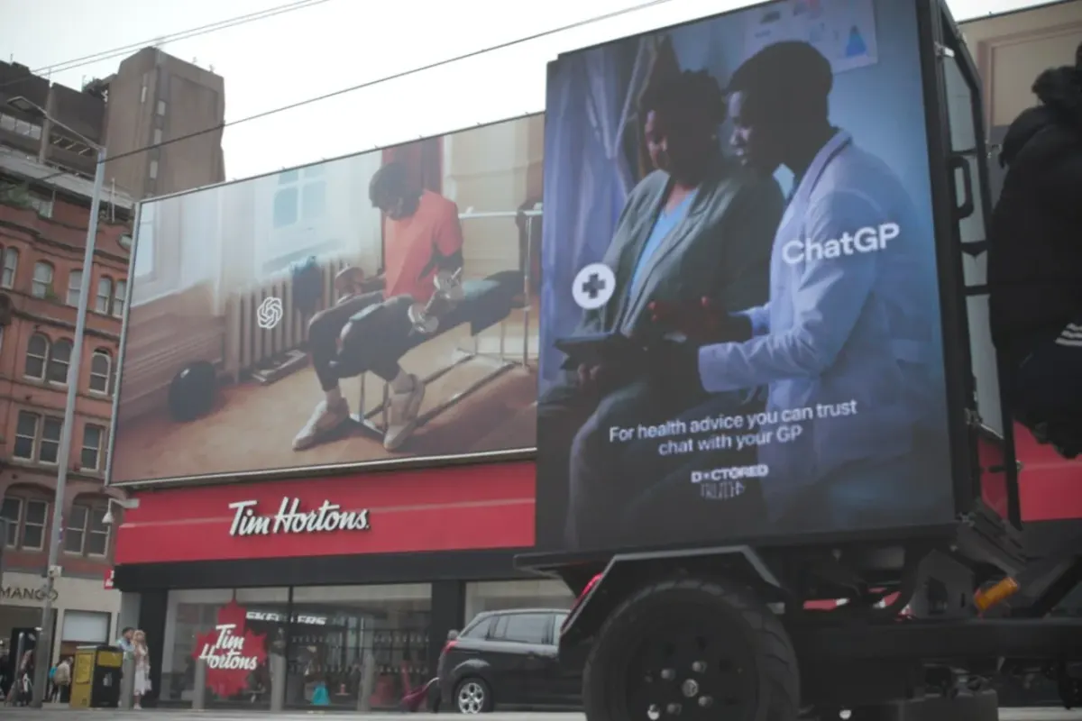Billboard truck with consultation-themed ad parked on a city street near a Tim Hortons storefront Billboard truck with consultation-themed ad parked on a city street near a Tim Hortons storefront
