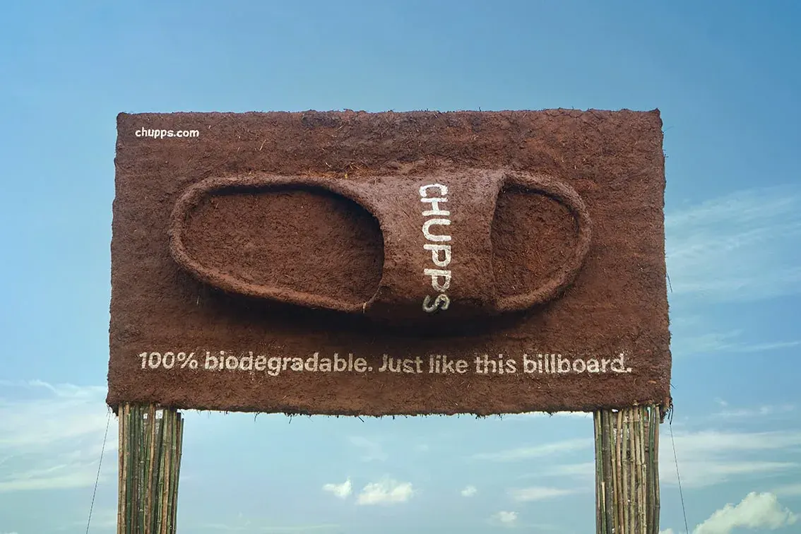 Chocolate-textured billboard reading 'CHUPS' with the slogan '100% biodegradable. Just like this billboard. Chocolate-textured billboard reading 'CHUPS' with the slogan '100% biodegradable. Just like this billboard.
