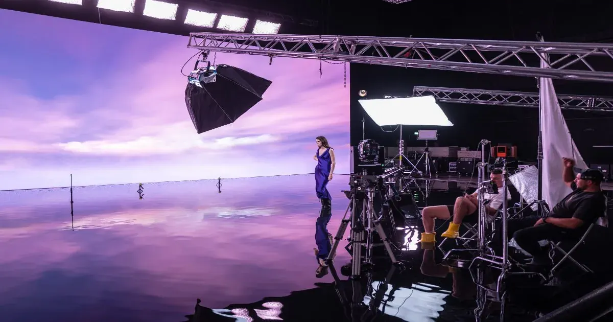 Studio shoot with a performer and film crew, relevant to game ad creative and UGC production